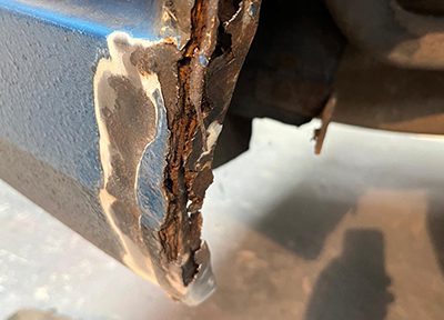 Severe corrosion on a vehicle panel before welding repair