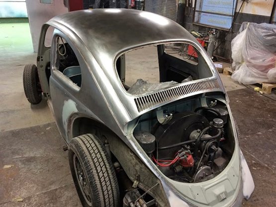 Classic Volkswagen Beetle body shell during rear-end repair work